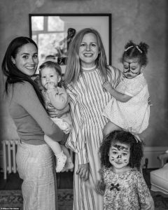 Lilibet is pictured here in her mother Meghan's arms, next to the Harriman family, which also includes the photographer's wife Camilla Holmstroem. Photo Credits - Misan Harriman PA